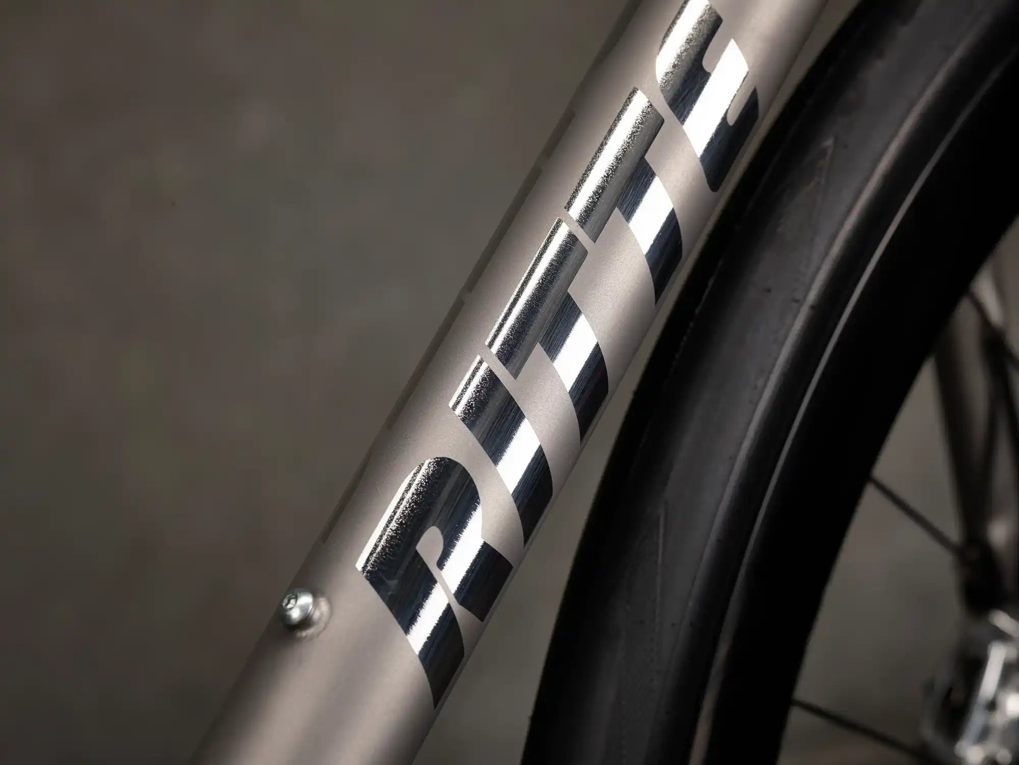 Close-up view of a bicycle frame with ’NINER’ text visible.