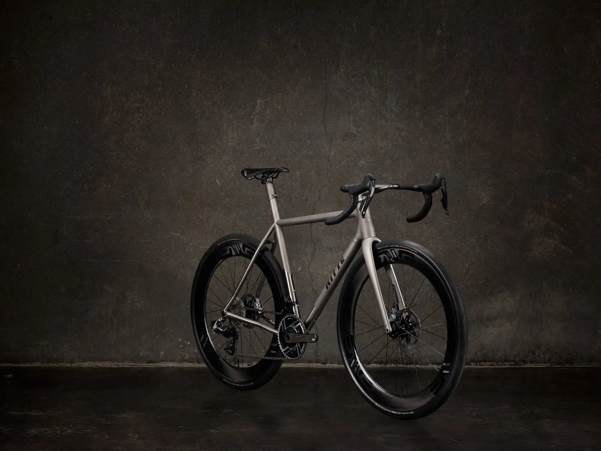 Sleek silver and black road bike with disc brakes and drop handlebars.