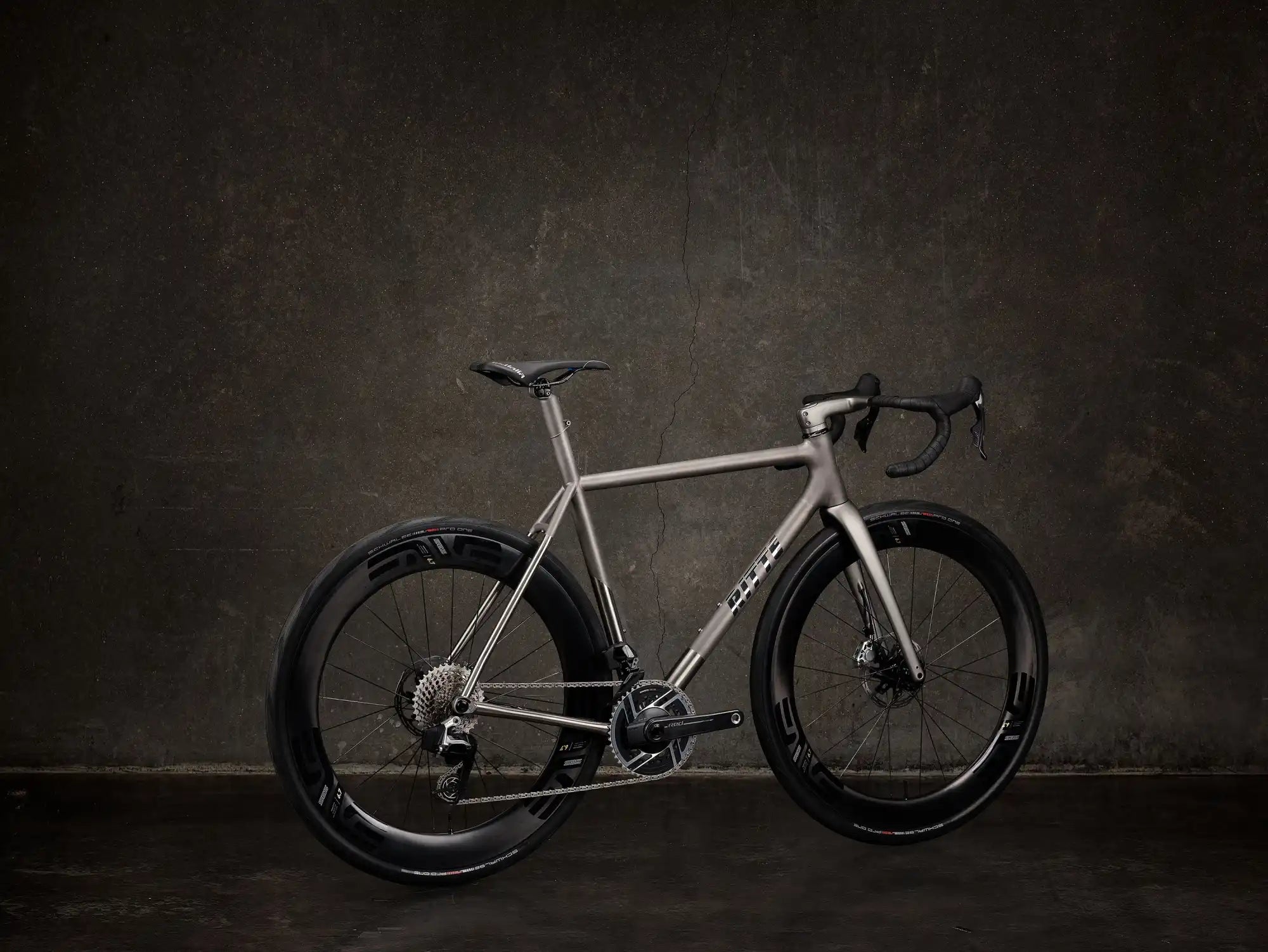 Sleek silver road bicycle with black wheels and disc brakes.