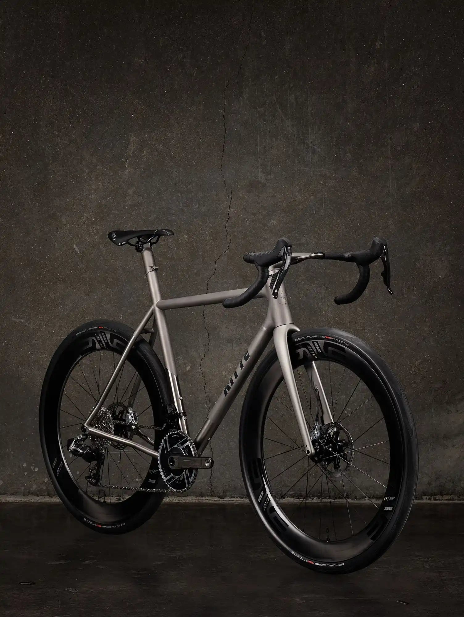 Sleek silver road bike with black components and drop handlebars.