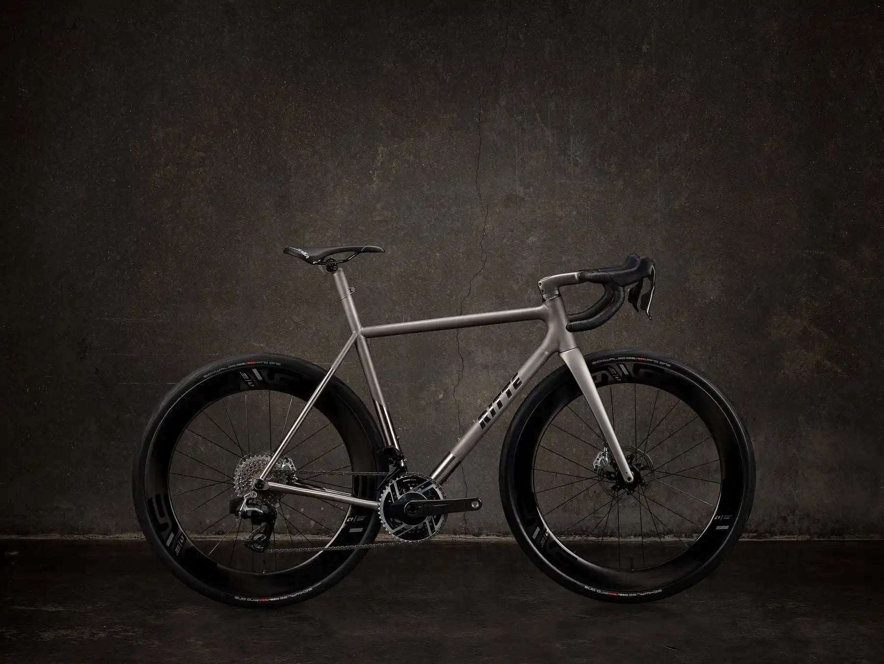 Sleek silver road bike with disc brakes and black wheels.