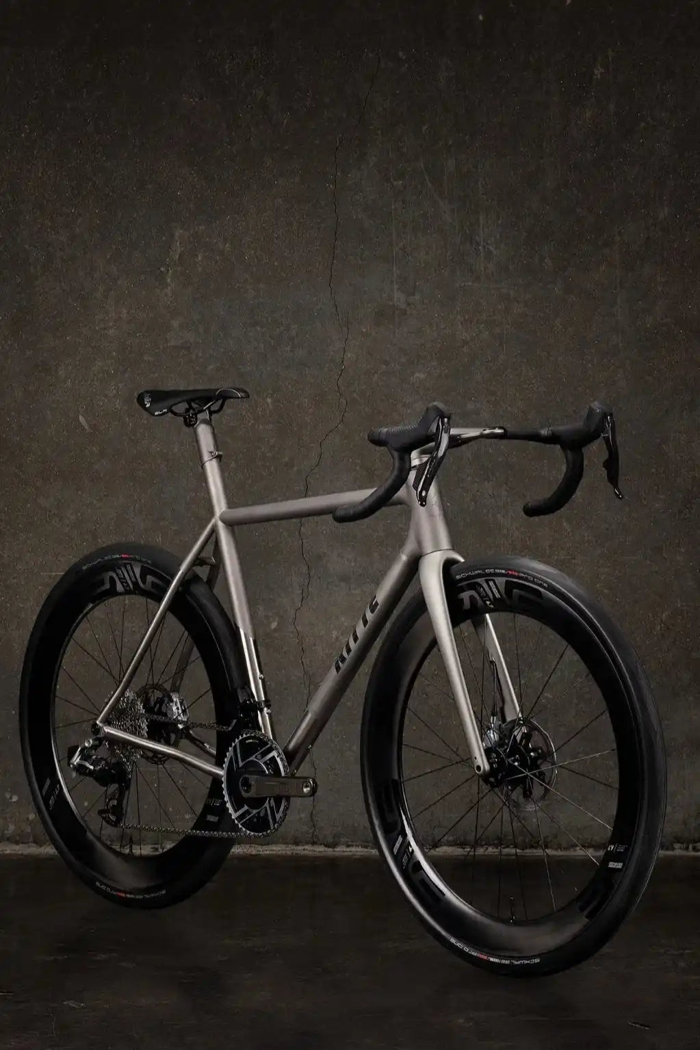 Sleek silver road bike with disc brakes and drop handlebars.