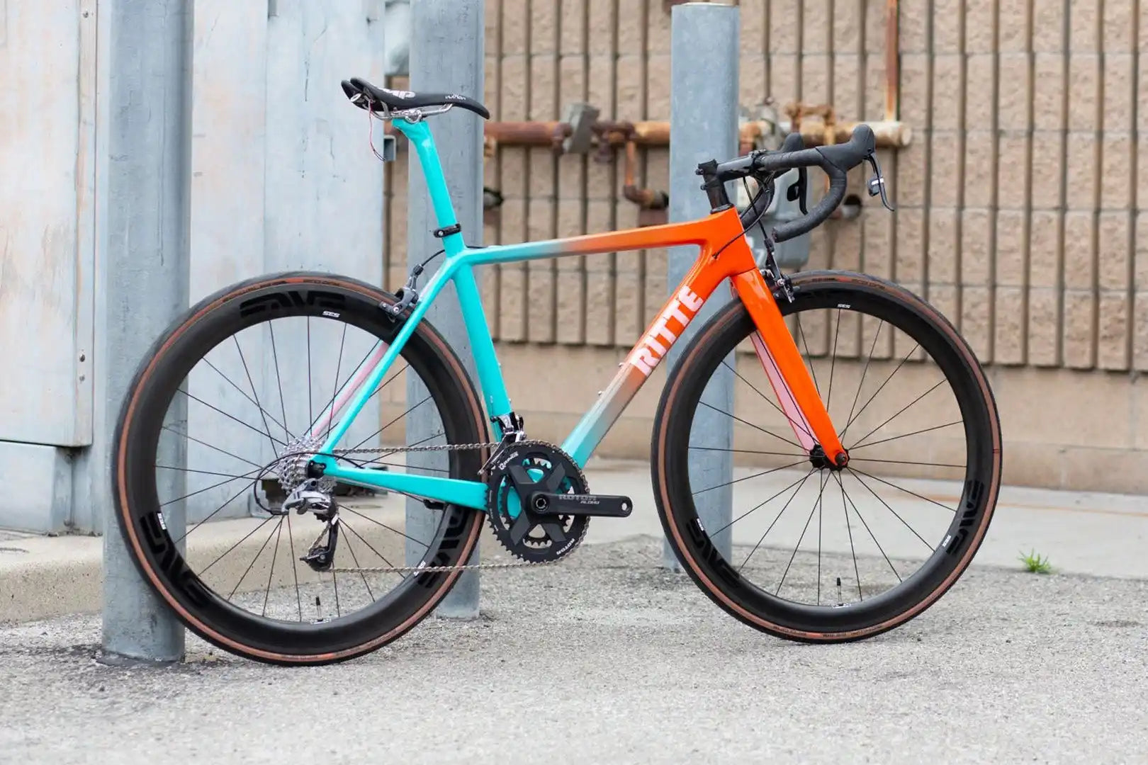 Racing bicycle with a turquoise and orange color scheme.