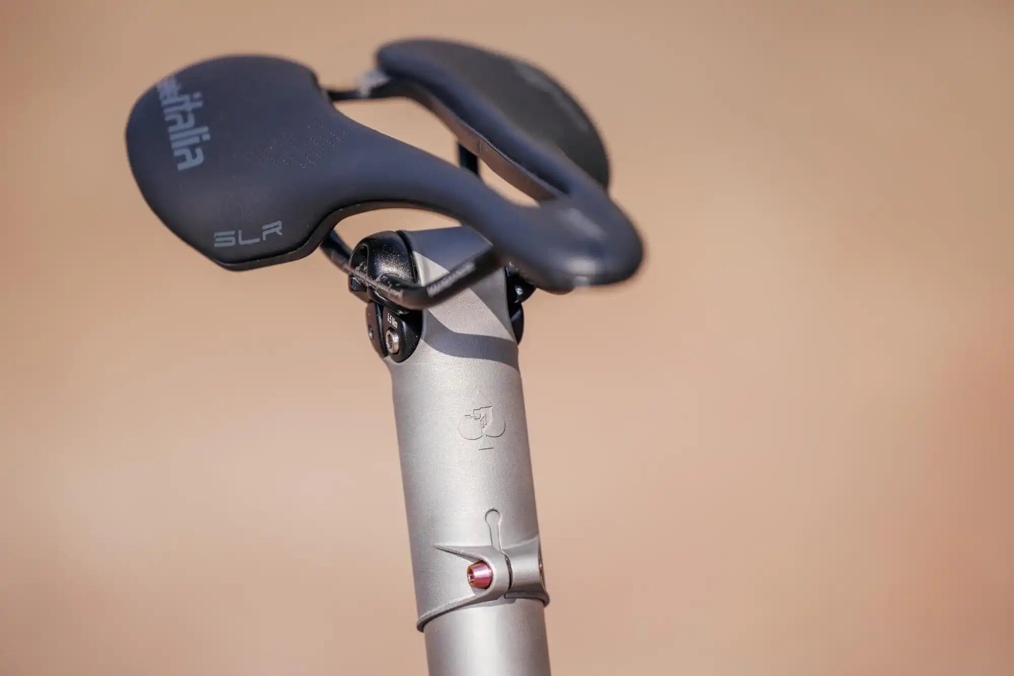 Black bicycle saddle mounted on a silver seatpost.