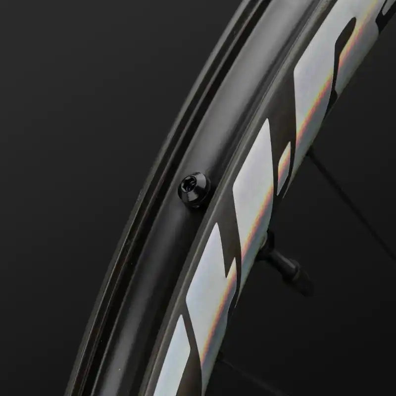 Black bicycle wheel rim with iridescent reflective strips.