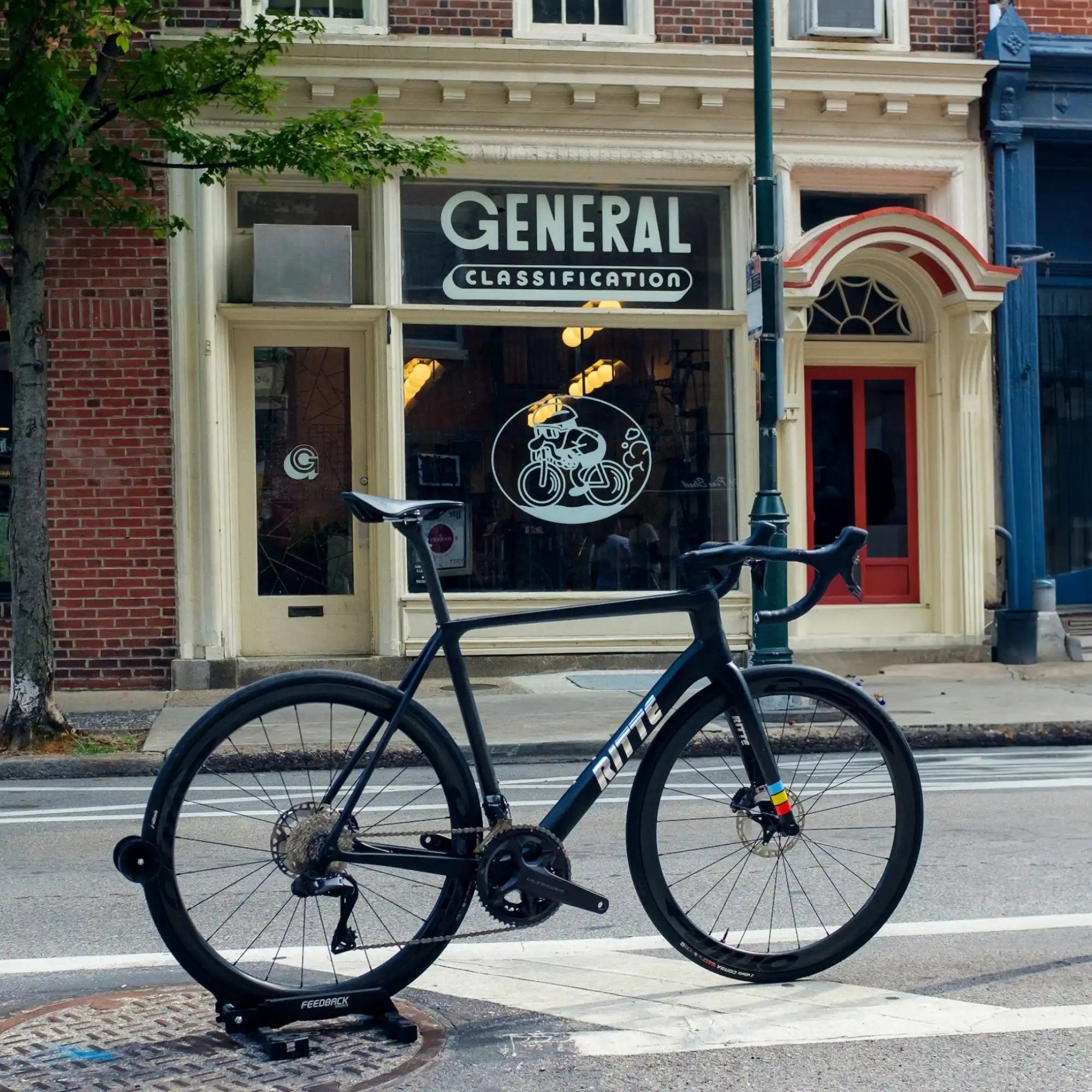 Black Route road bike parked on a bike stand.