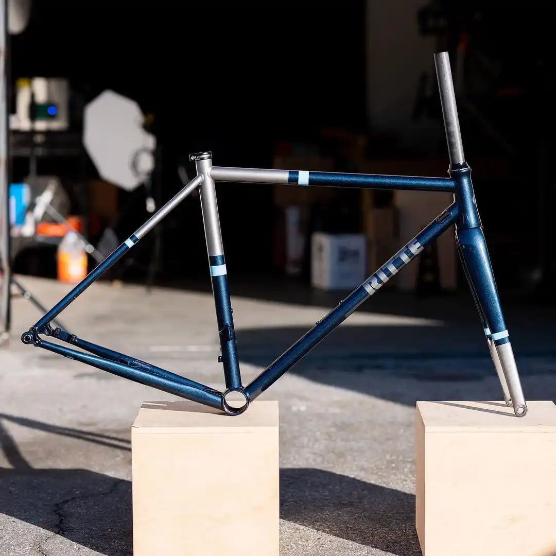 Blue and silver bicycle frame with clean geometric lines.