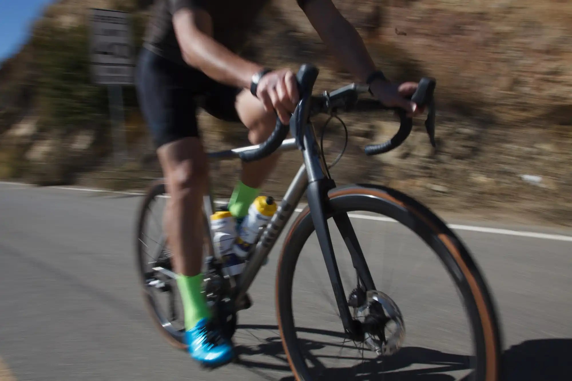 Blurry cyclist on a road bike.