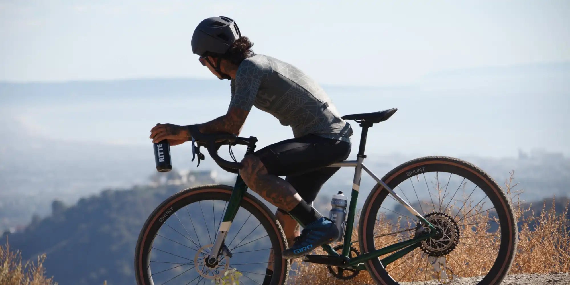 Cyclist riding a gravel bike in an aerodynamic position.