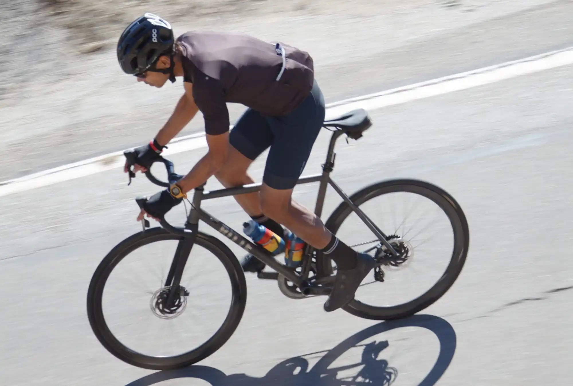 Modern road bike with disc brakes and a cyclist in riding position.