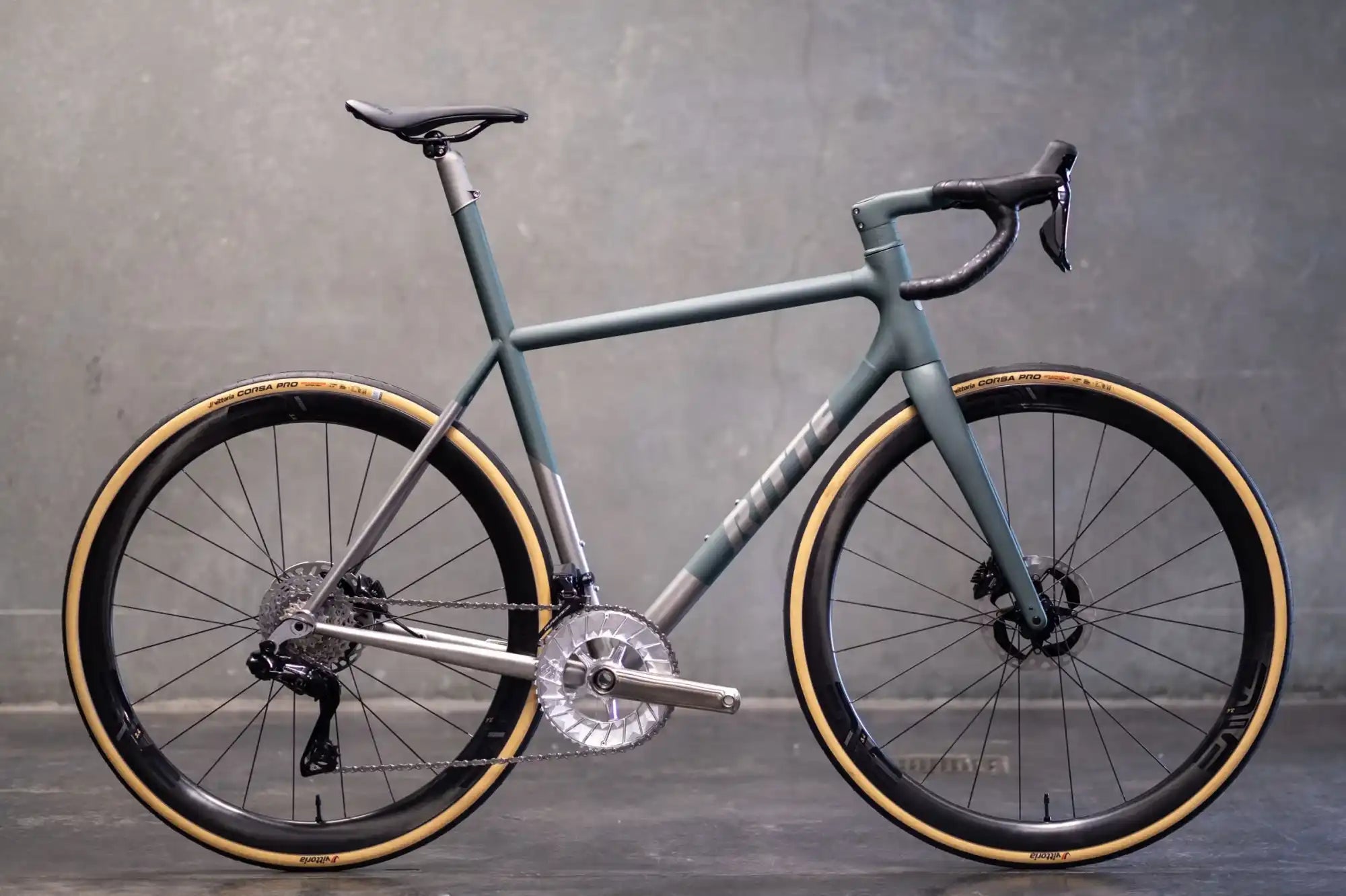 Sleek gray road bike with tan sidewall tires and disc brakes.